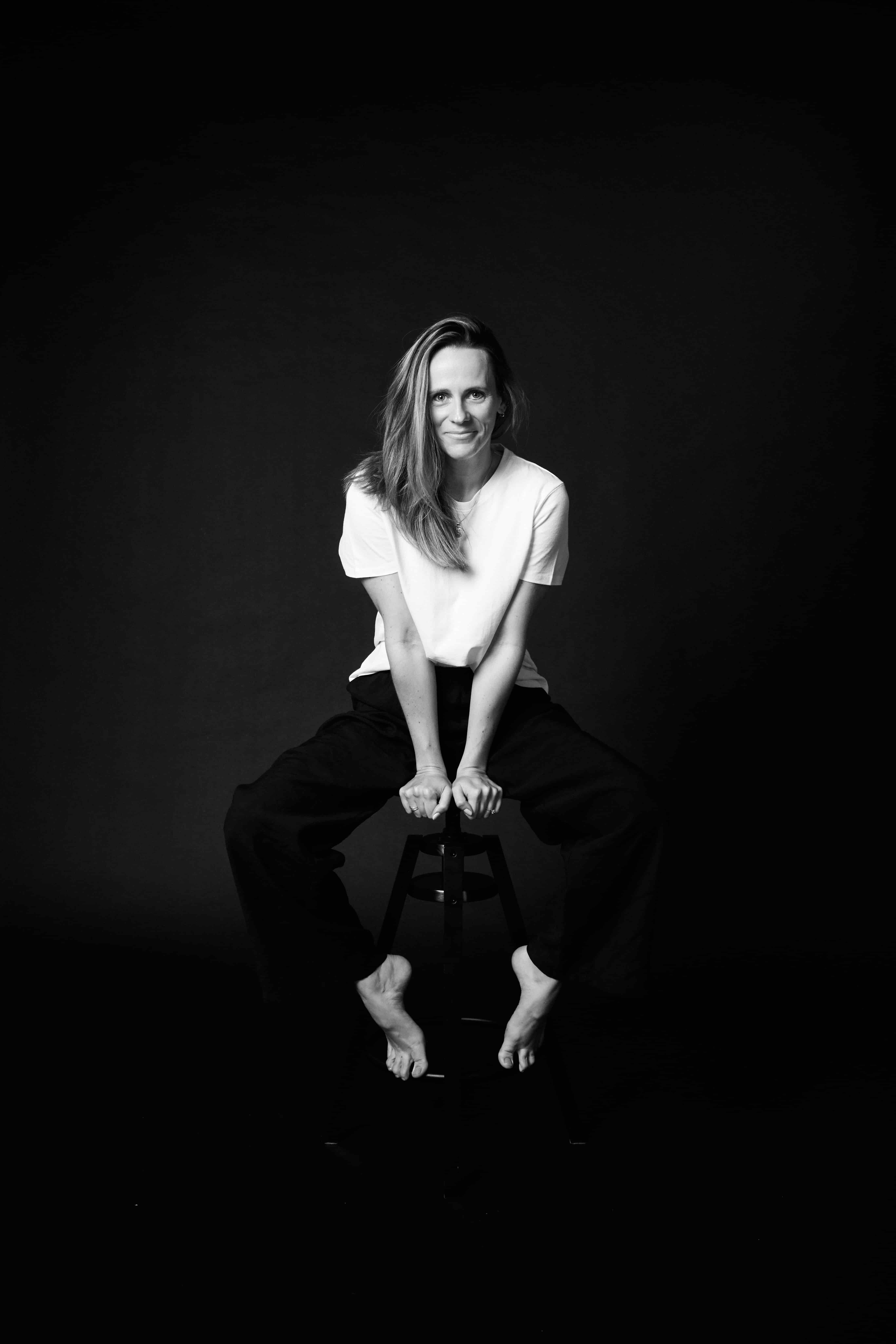 Chloe Cooper, seated, full length, on black