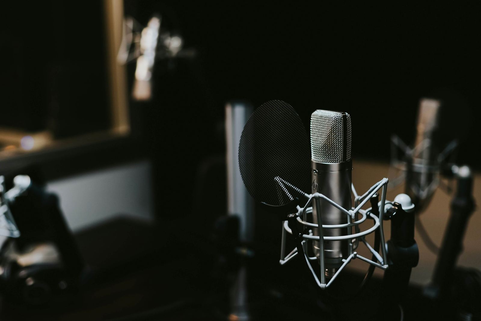 A studio microphone in a dark recording room